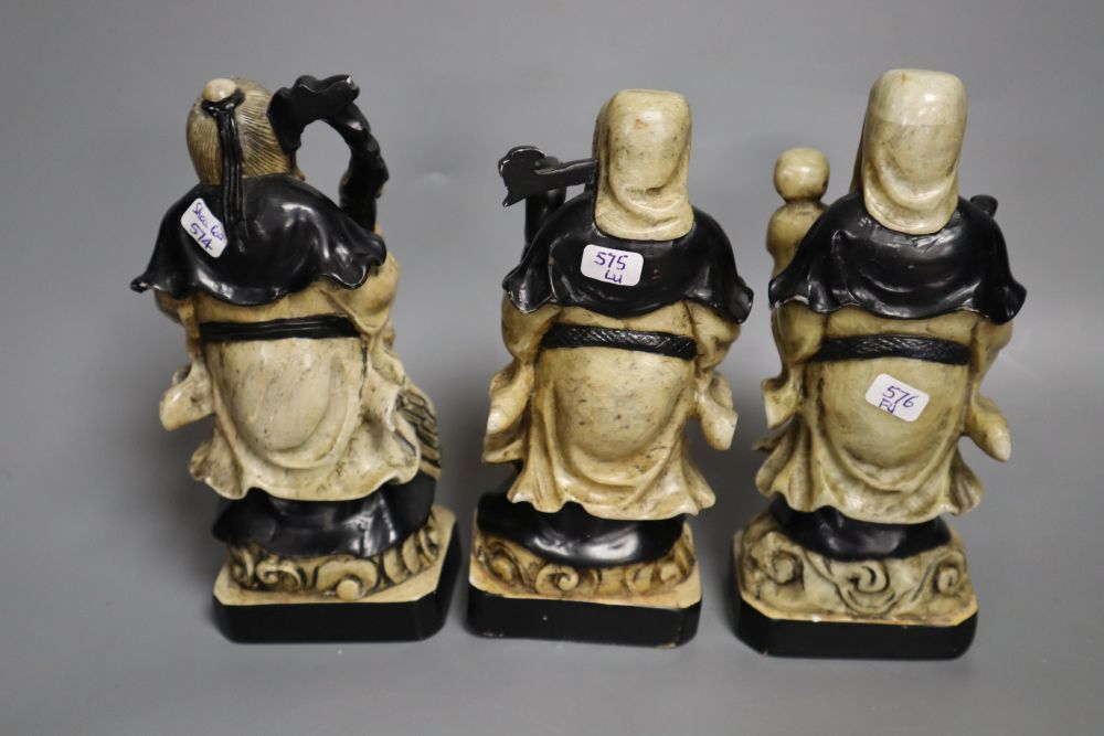 A set of three Chinese soapstone figures of the Star Gods and a soapstone brush rest, tallest 16.5cm